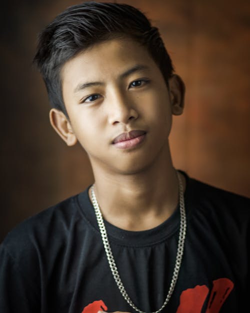 Photography of Boy Wearing Silver Necklace