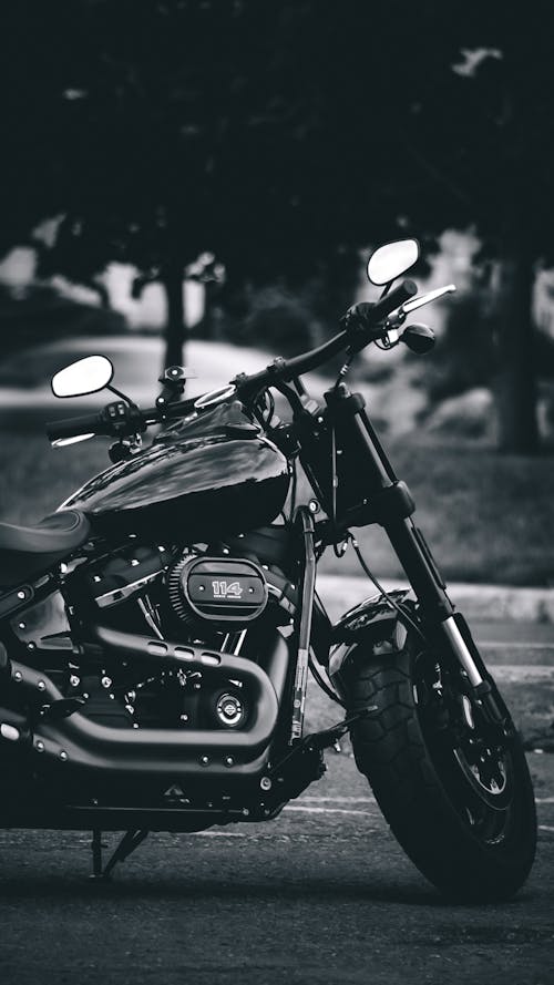 Free Grayscale Photo of Motorcycle Near Street Light Stock Photo