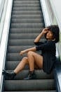 Woman with Afro Hairstyle Posing on Escalator