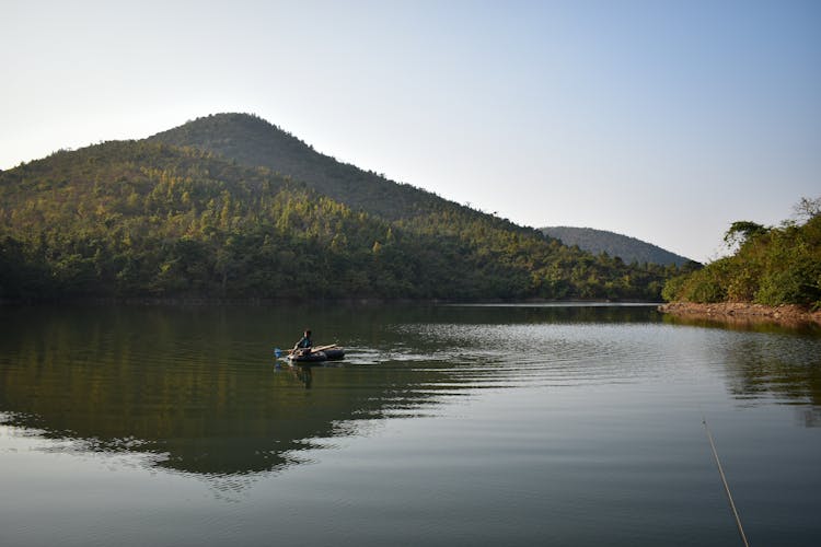 A Person Riding On A Raft Floating On The Lake