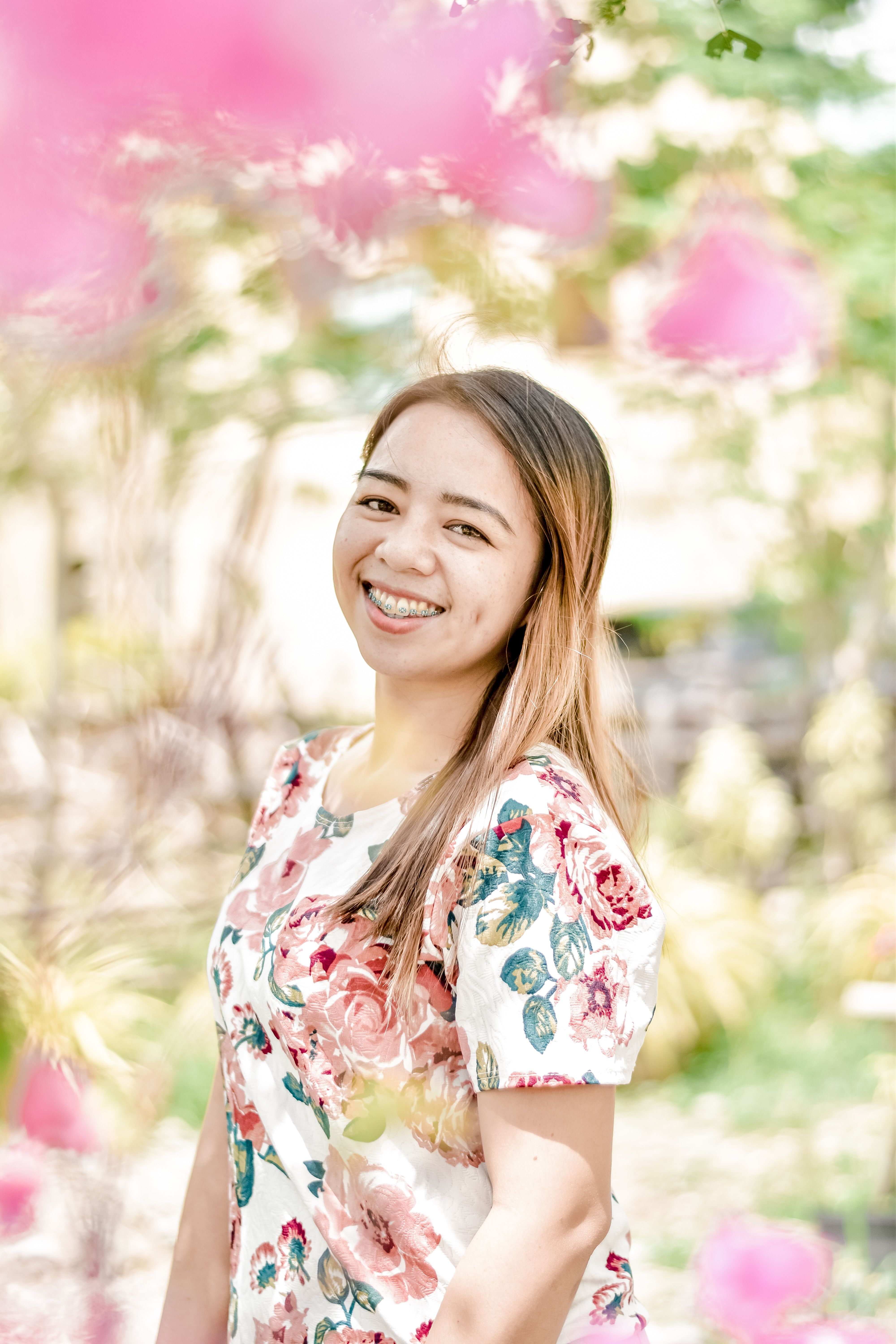A Woman Wearing Floral Dress Against the Blurry Background · Free Stock ...