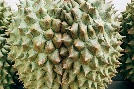 Detailed close-up of durian fruit's spiky texture highlighting its unique surface patterns.
