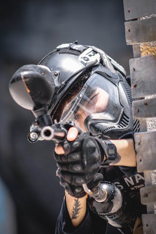 Free Man in Military Uniform and Helmet Aiming with Weapons Stock Photo
