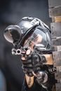 Man in Military Uniform and Helmet Aiming with Weapons