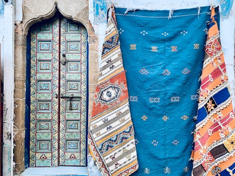 Ornate doorway with vibrant woven rugs, showcasing cultural artistry and vibrant patterns.