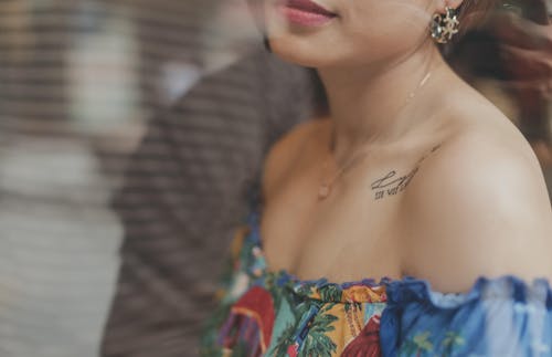 Close Up Photo of Woman Wearing Off Shoulder Top