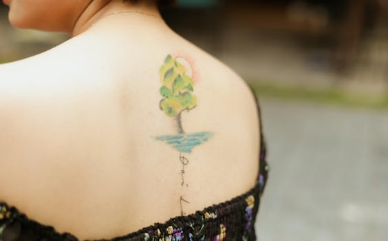 Close-up of a colorful tree tattoo on a woman's back, showcasing intricate design