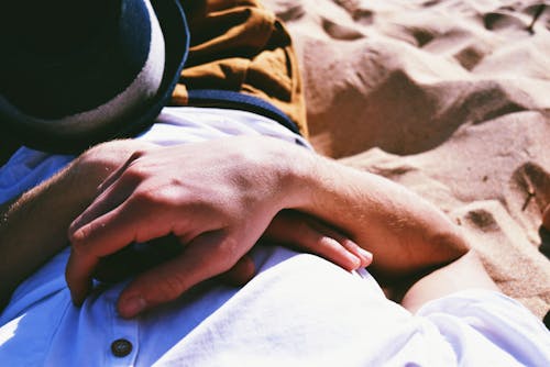 Person Lying on Sand