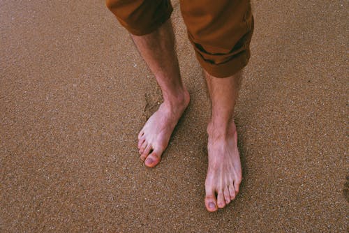 Free Close Up Photo of Person Standing on Seashore Stock Photo