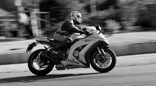 Black and White Photo of Person Riding a Motorcycle