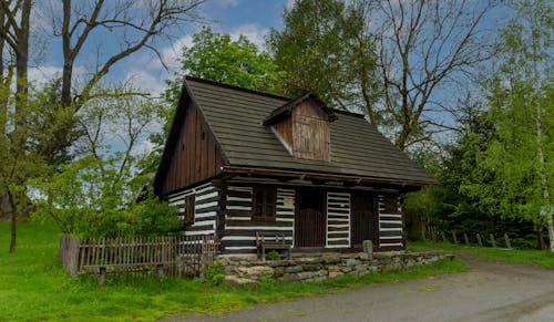 Brown Wooden House Near Green Trees