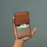 A hand-stitched leather card pouch, photo by Candy Flipping on Pexels