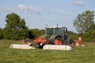 Fendt tractor mowing a meadow