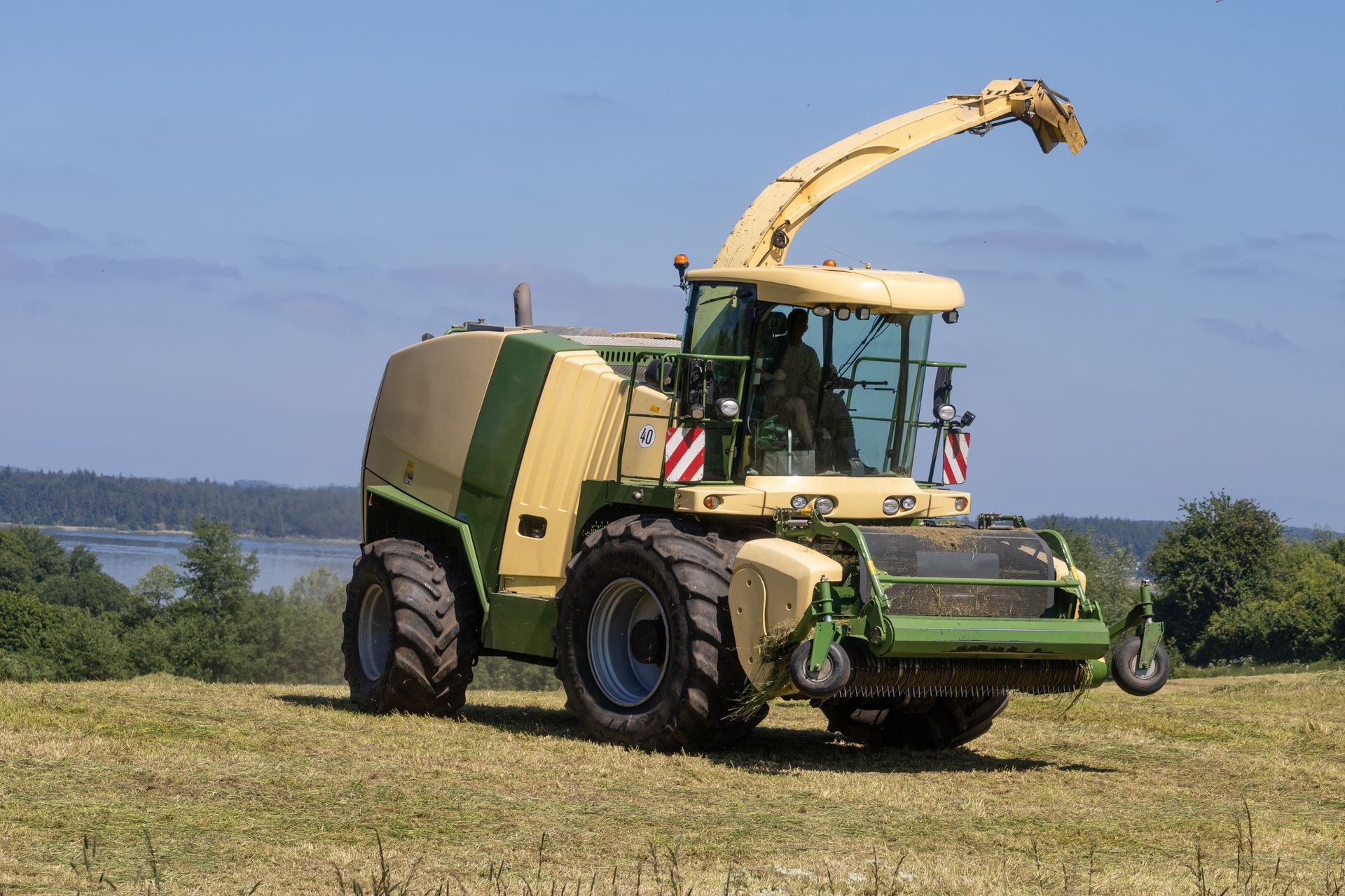 Agricultural machinery operating on a sunny day, showcasing advanced farming techniques.