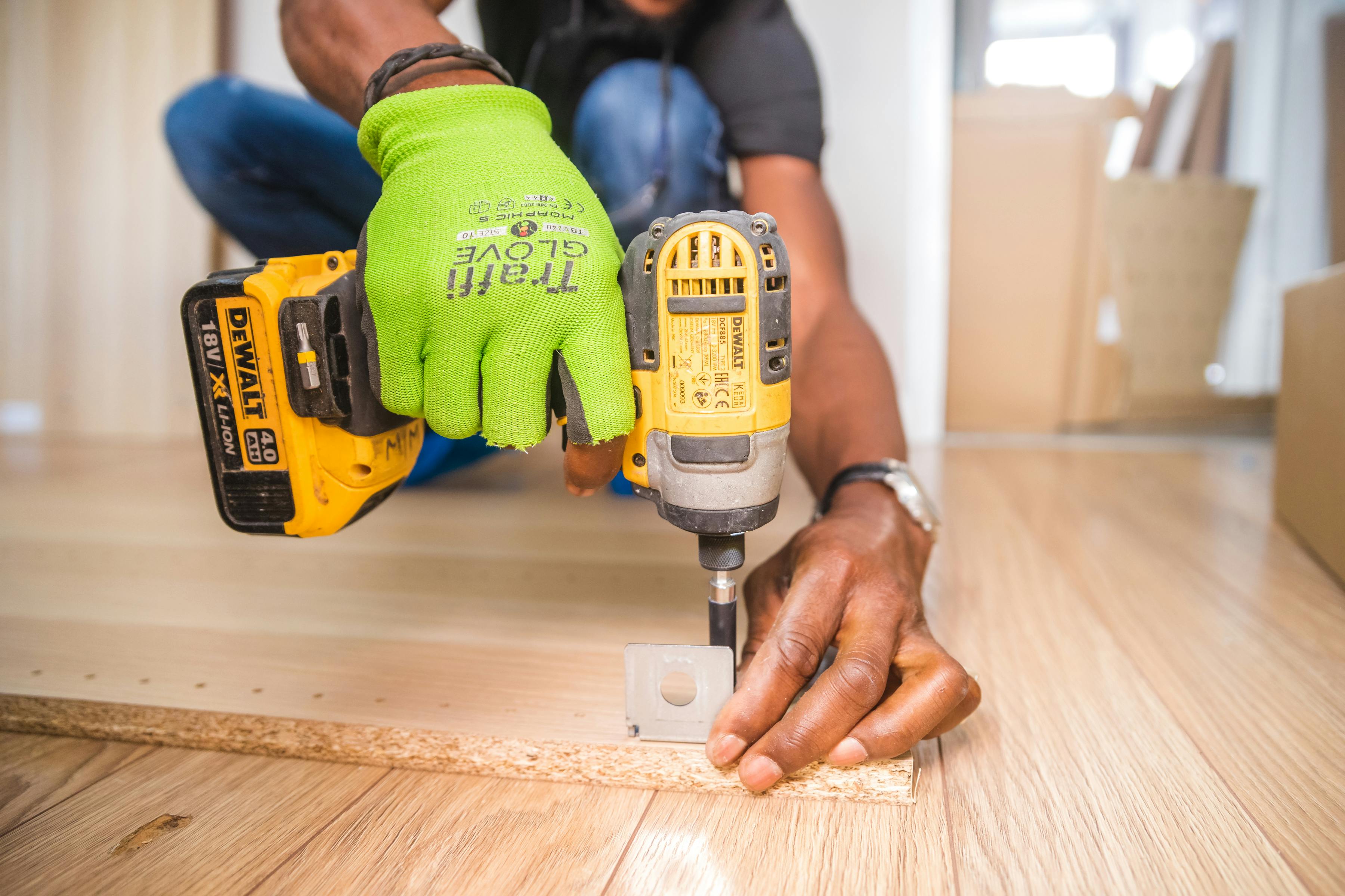 Person Using Dewalt Cordless Impact Driver on Brown Board Free