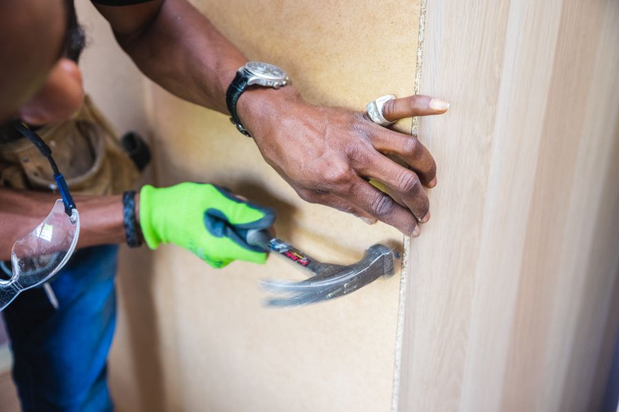 Installer using tools to assemble furniture at a customer's home
