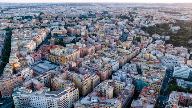 Stunning aerial perspective of a vibrant cityscape at dusk showcasing dense urban architecture.