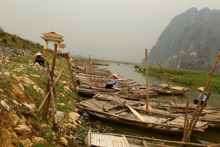 People In Boats On River