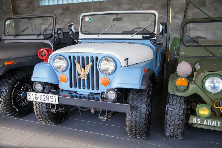 Vintage Military Jeeps In A Garage