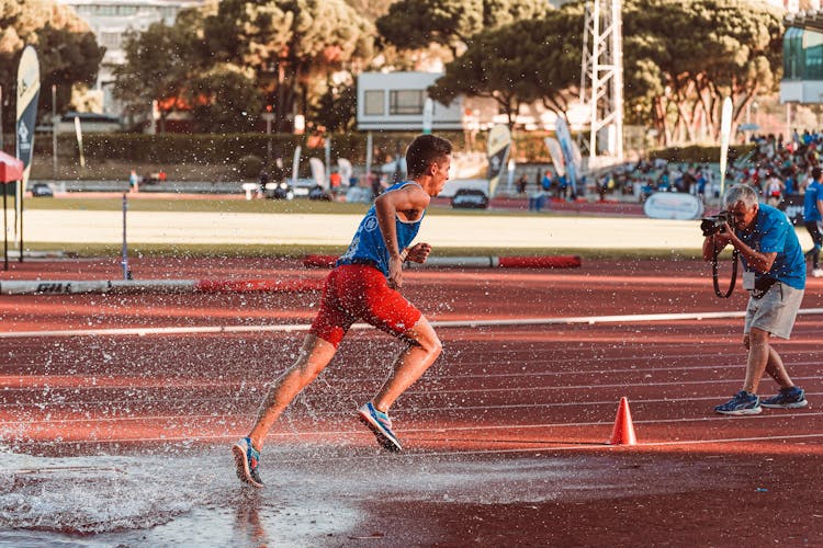 Athlete Running On Stadium