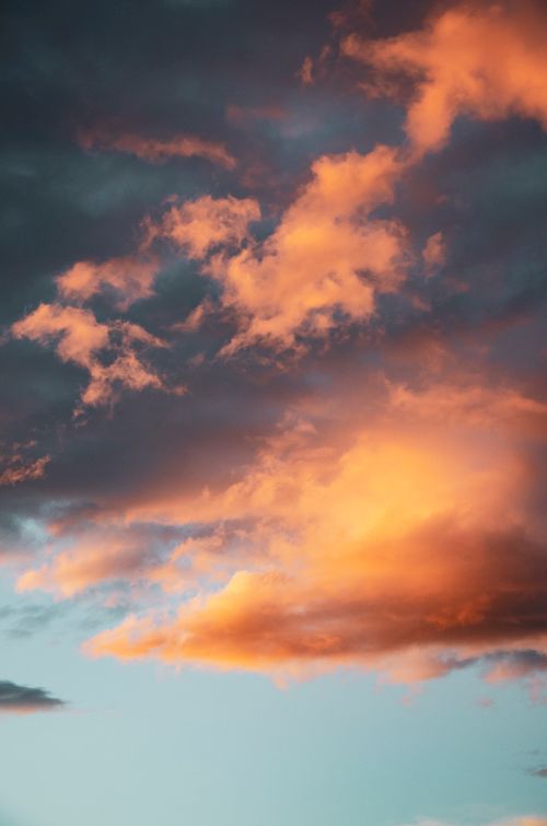 Free Captivating sunset with vibrant golden clouds against a clear sky. Stock Photo