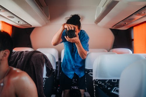 Man in Blue Polo Taking Photo with a Camera