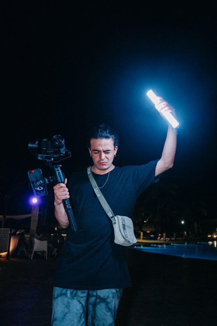 Man Holding Camera And Flashlight