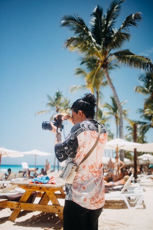 Man Taking Picture near Palm Tree