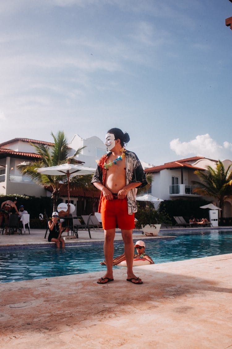 Man In Mask Standing Near Swimming Pool