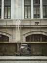 Black Bicycle Parked Beside White Concrete Building