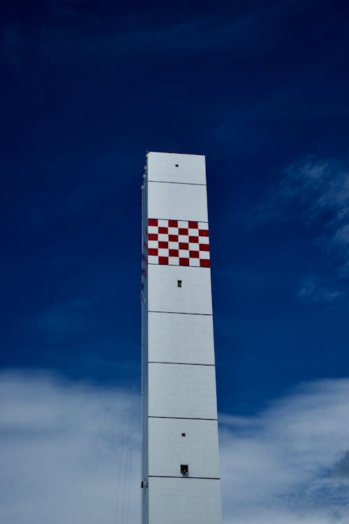Free White and Red Concrete Tower Under Blue Sky Stock Photo