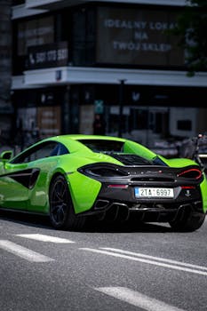 Vibrant green sports car moving through city streets, highlighting luxury and speed.