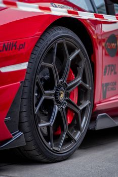 Detailed close-up of a luxurious Lamborghini car wheel showcasing sleek design.