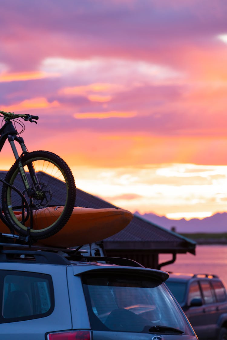 A Mountain Bike On Top Of A Sports Utility Vehicle