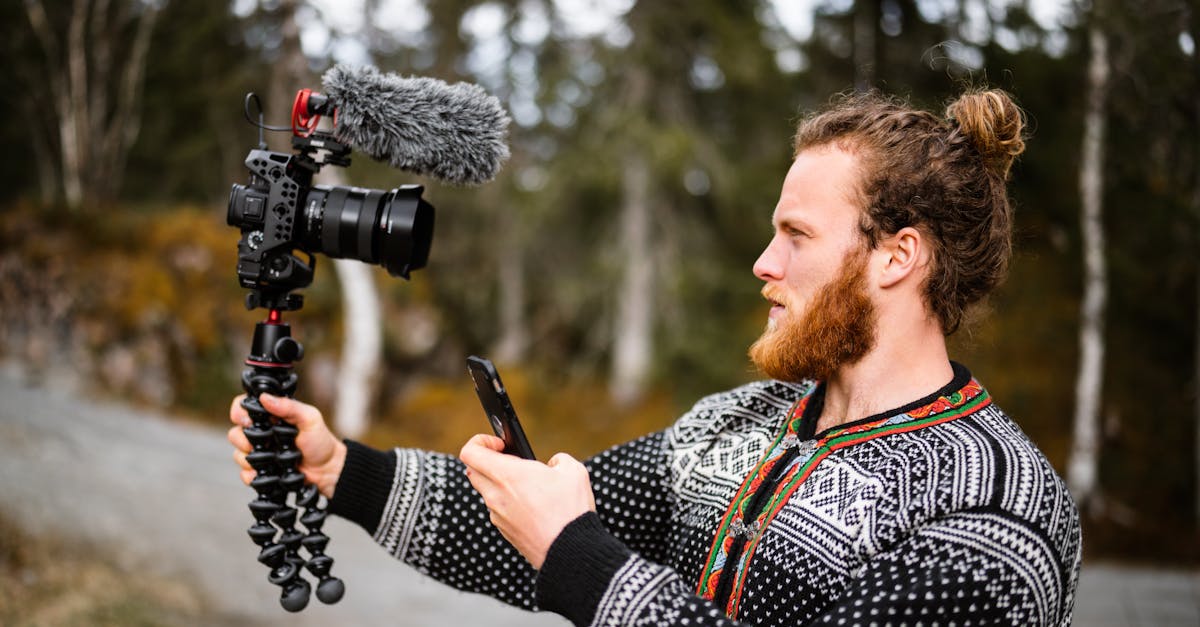 Man with Professional Camera Filming Outdoors · Free Stock Photo