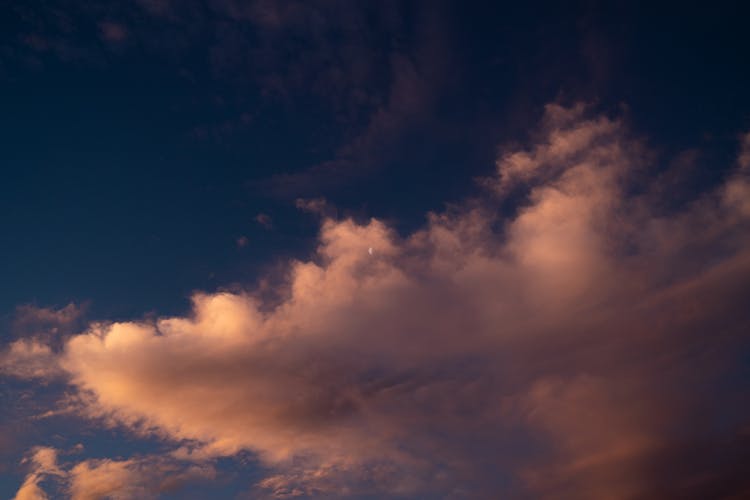 Moon Above Pink Clouds In Sky