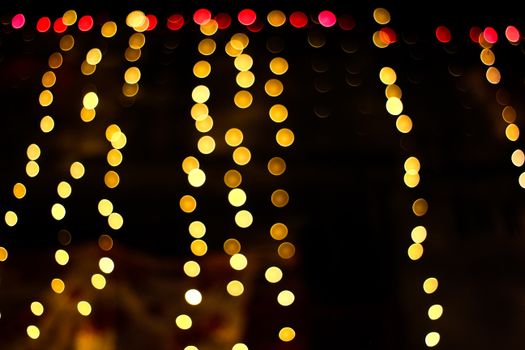 Abstract golden bokeh lights create a festive and dreamy atmosphere, perfect for holiday themes.