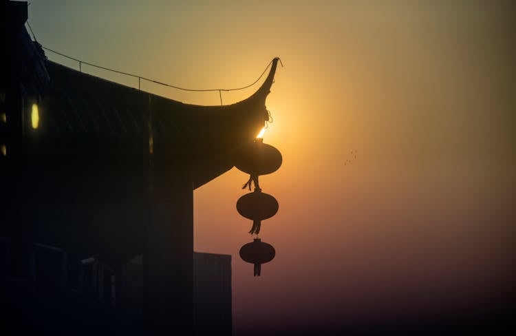 Silhouette Of A Hanging Ornament Near A Building