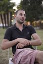 Man in Black Polo Shirt Sitting on White Chair