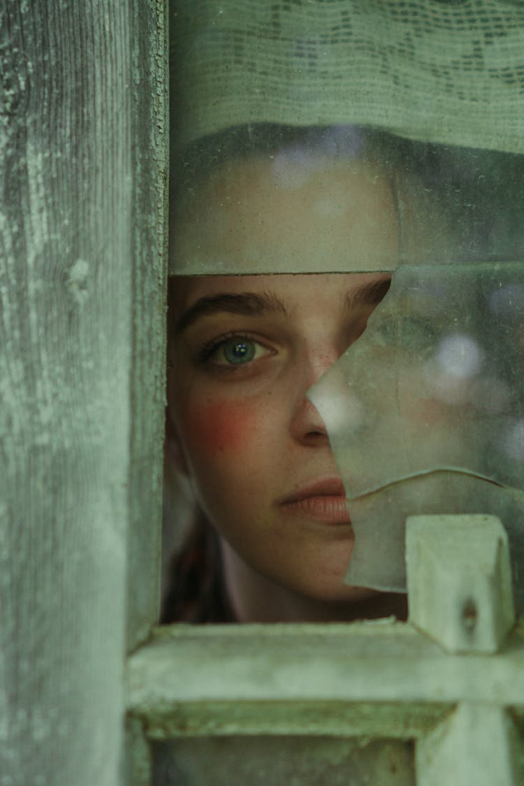 Woman Behind A Broken Window