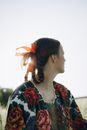 Woman in Blue and Green Floral Shirt
