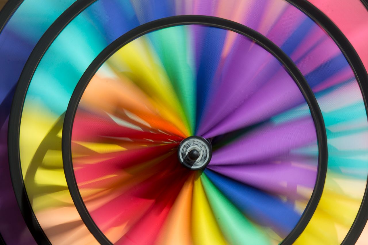 dynamic close up of a colorful spinning wheel displaying a vivid rainb