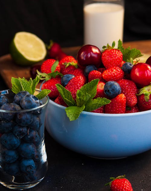 Free Strawberries and Blueberries in Blue Ceramic Bowl Stock Photo