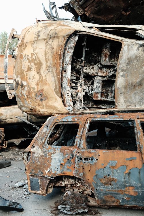 Free A stack of heavily rusted and abandoned cars in a scrapyard, showcasing decay. Stock Photo
