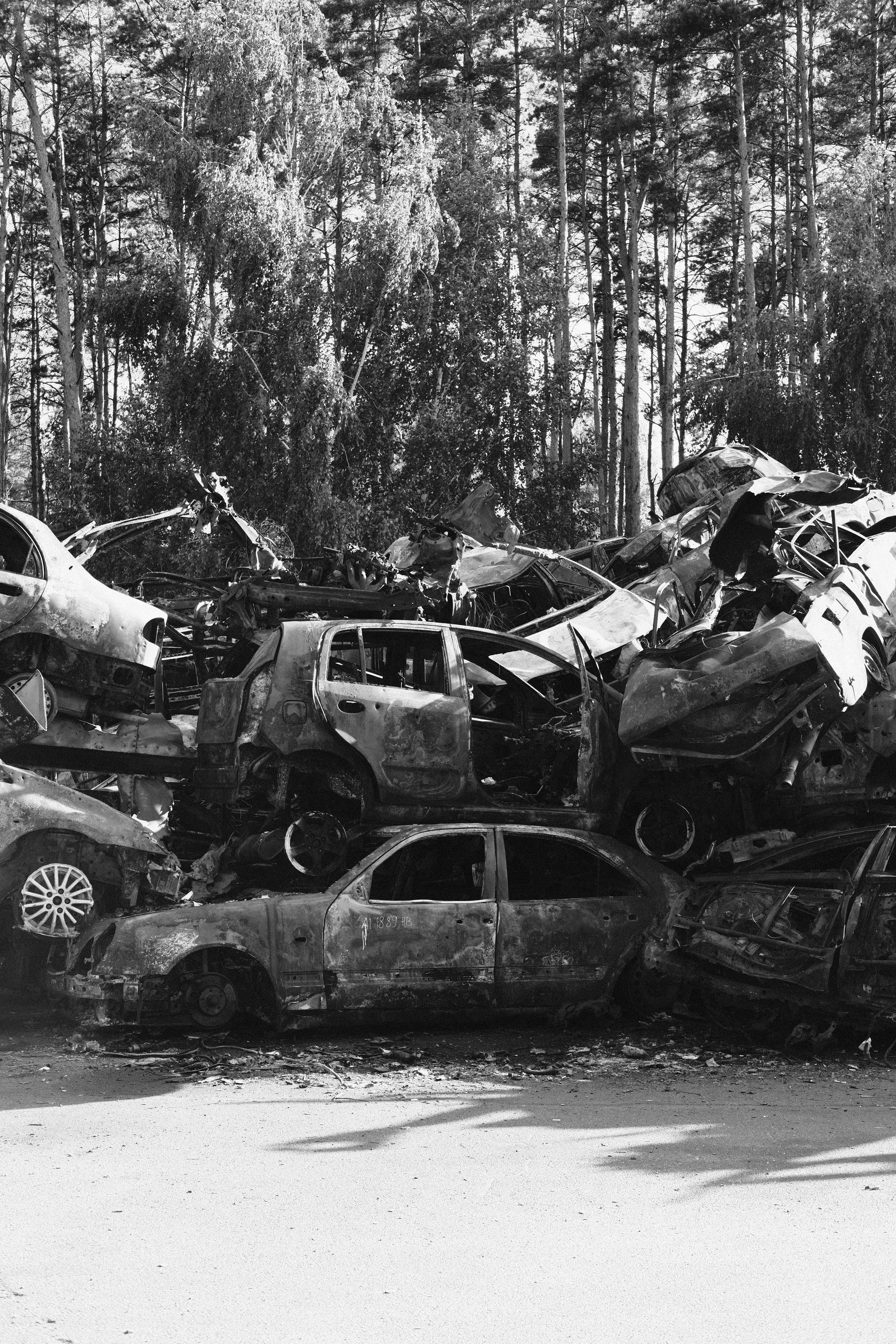 Free Grayscale Photo of a Pile of Wrecked Cars Stock Photo