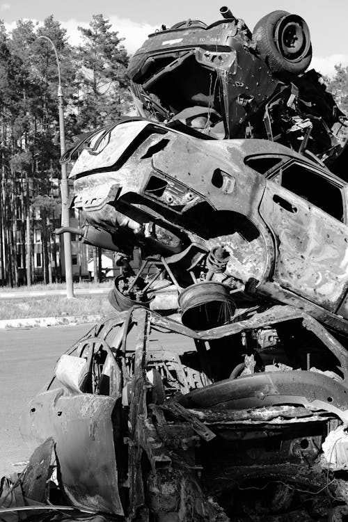 Grayscale Photo of Junked Cars