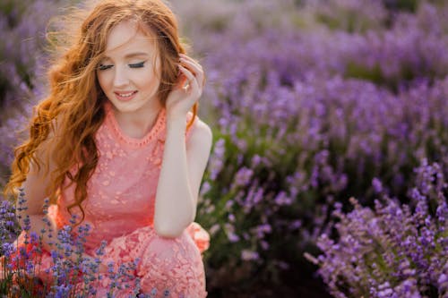 Young Redhead Woman Sitting in Lavender Field