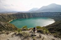 Woman Sitting near Lake in Nature Landscape