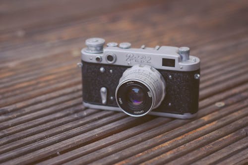 Free Black and Gray Film Camera on Brown Wooden Surface Stock Photo