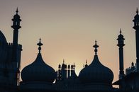 Capturing the iconic Royal Pavilion domes silhouetted against a vibrant sunset sky in Brighton, UK.
